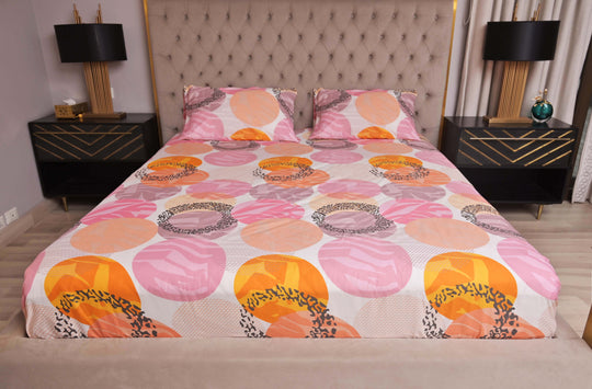 Bed with a colorful floral patterned bedspread in a bedroom setting.