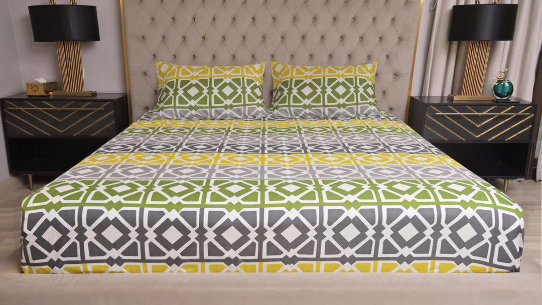 Bed with patterned bedding in a bedroom setting with nightstands and lamps.