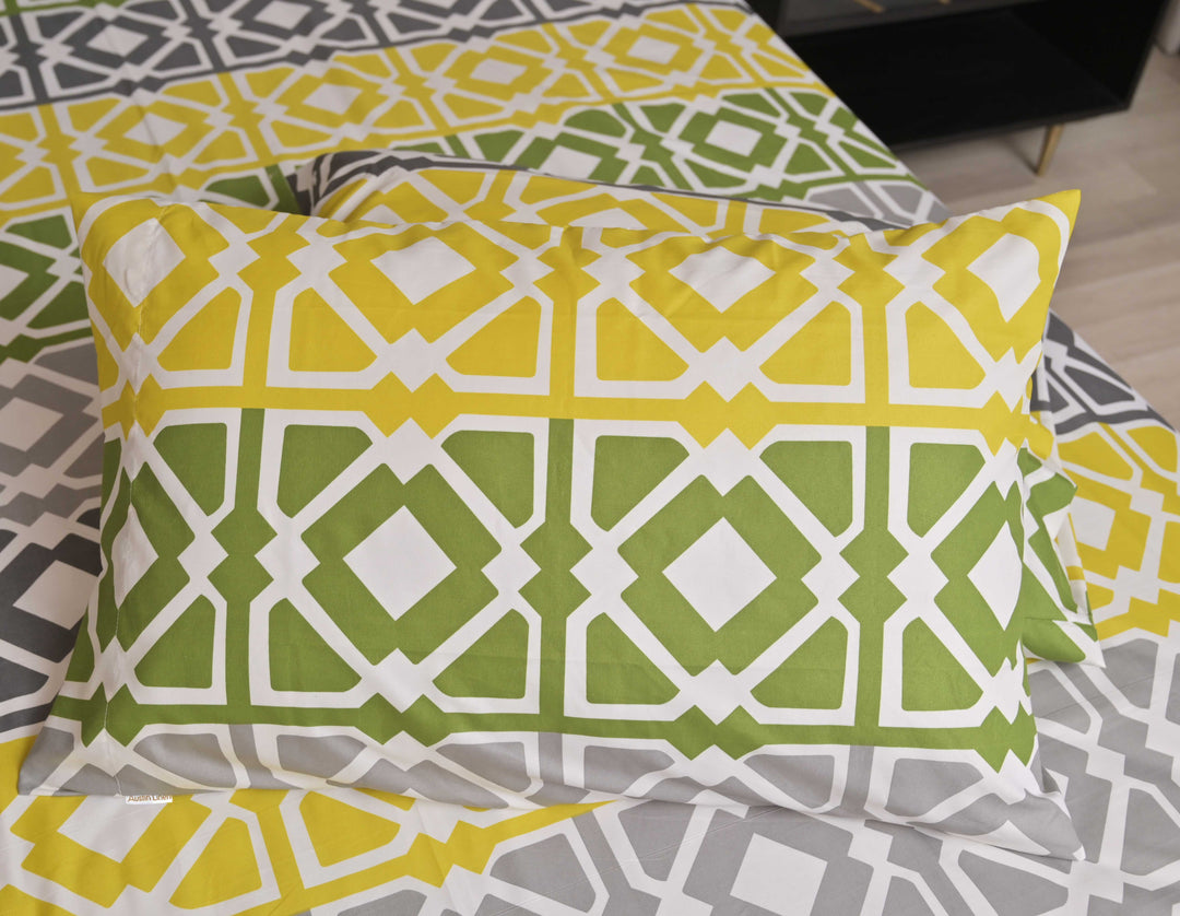 Patterned pillow on a bed with a geometric design