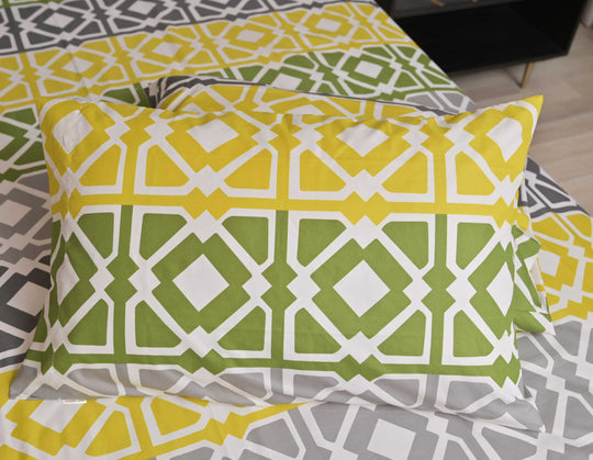 Patterned pillow on a bed with a geometric design