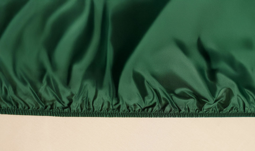 Close-up of green fabric with a beige background