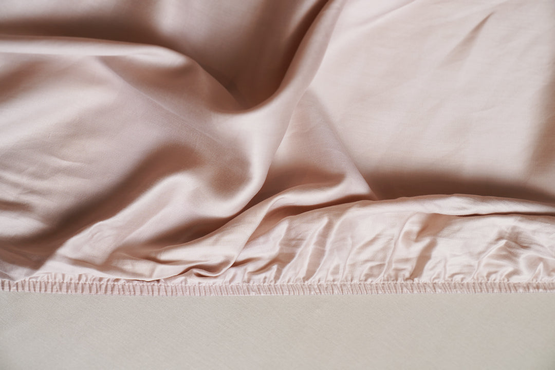 Close-up of light pink fabric with a subtle texture